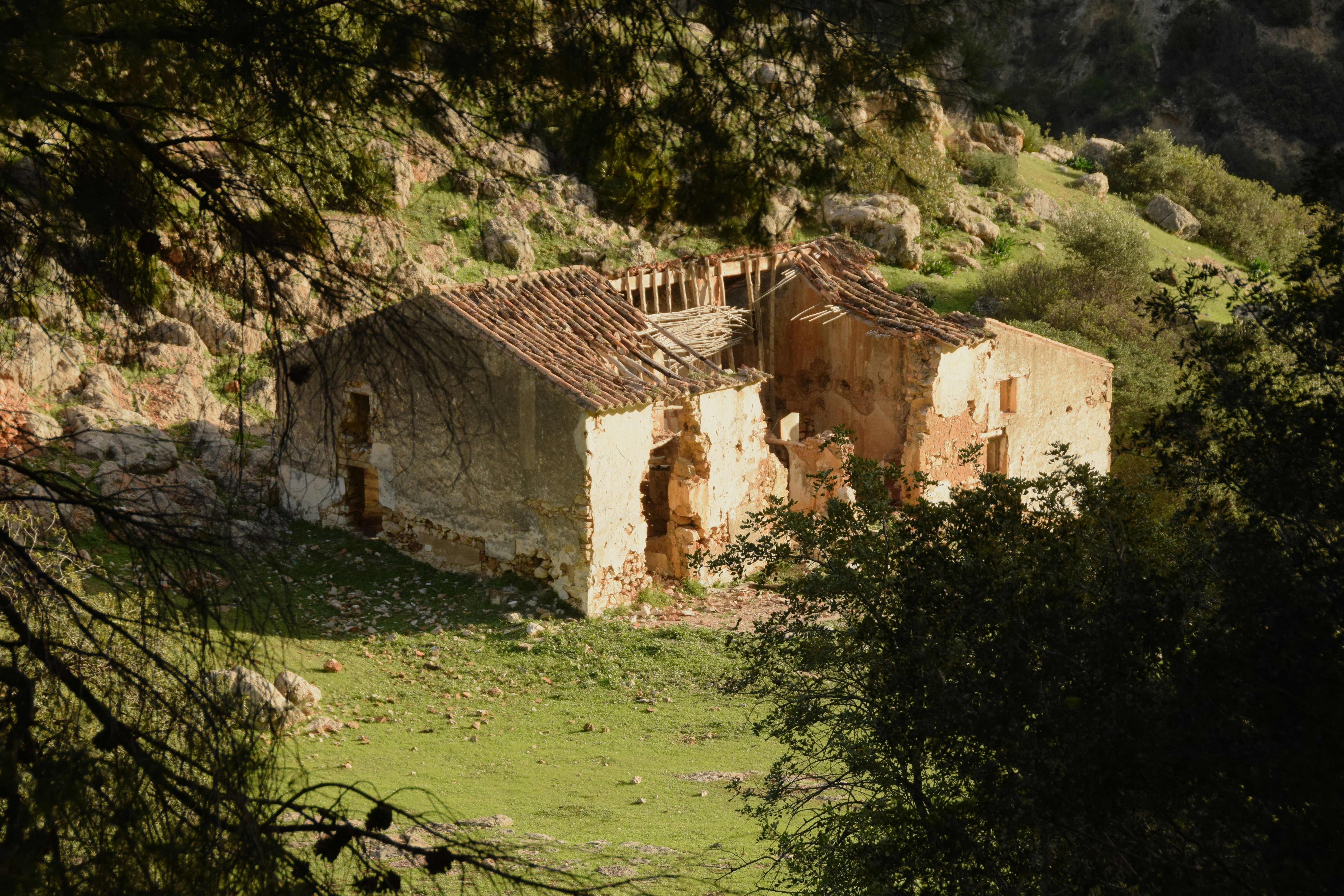 Modern living room with a blue sofa, beige armchair, and glass coffee tables